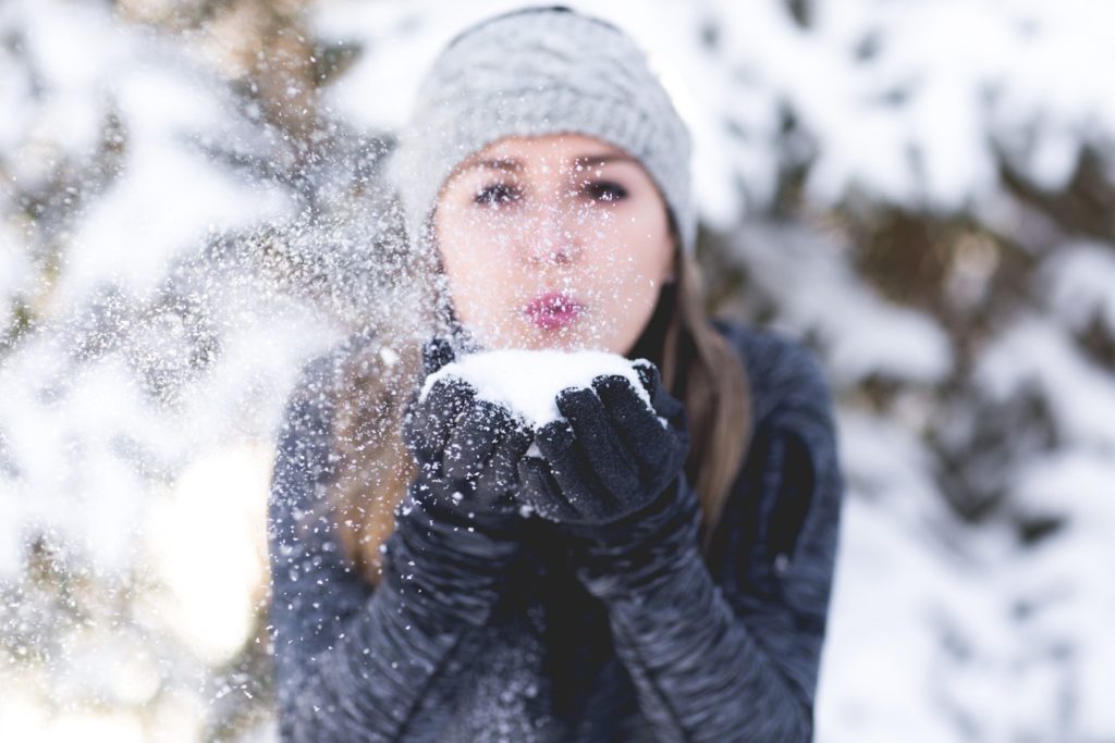 women blowing snow into the camera Heat Press Machine - Insta Graphic Systemsf